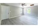 Open concept living area with gray walls, modern floors, ceiling fan, and front door at 340 Whitner St, Rock Hill, SC 29730