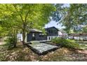 Spacious backyard featuring a newly installed concrete patio with mulch border at 3801 Woodleaf Rd, Charlotte, NC 28205
