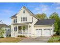 Beautiful two-story home with a covered front porch and a spacious three-car garage, exuding curb appeal at 4012 Spring Cove Way, Belmont, NC 28012