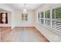 Bright dining room with wood floors, white shutters, and stylish chandelier at 4915 Huntington Farm Rd, Catawba, SC 29704