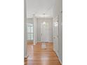 Bright foyer with hardwood floors, column accents and a view of the front windows at 5311 Courtfield Dr, Indian Trail, NC 28079