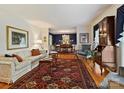 Spacious living room showcasing hardwood floors, a classic rug, and stylish furnishings at 6420 Saint John Ln, Charlotte, NC 28210
