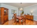 Formal dining room with hardwood floors, chandelier, and classic furnishings at 6634 Rocky Falls Rd, Charlotte, NC 28211