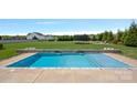 Relaxing backyard in ground pool with manicured lawn, great for entertaining guests at 708 Brookmeade Dr, Waxhaw, NC 28173