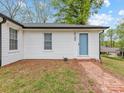 Charming home with a brick pathway leading to the light blue front door and white siding at 721 Broad St, Kannapolis, NC 28081