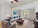 Bright living room featuring stylish furniture, hardwood floors, and a large window at 721 Broad St, Kannapolis, NC 28081