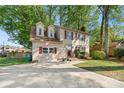 A classic two-story home showcases a lush yard, red shutters, and dormer windows, providing curb appeal at 7220 Spring Morning Ln, Charlotte, NC 28227