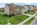 Beautifully landscaped front yard with lush green grass and a healthy tree, enhancing the home's curb appeal at 7362 Waterwheel Sw St # 280, Concord, NC 28025