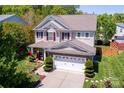 Aerial shot of a well-maintained two-story home with a two car garage and manicured lawn at 739 Ivy Trail Way, Fort Mill, SC 29715