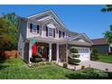 Charming two-story home with stone accents, covered porch, red shutters and manicured yard at 739 Ivy Trail Way, Fort Mill, SC 29715