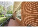Close-up view of the brick exterior with white-framed windows and a charming brick walkway at 821 Mark St, Belmont, NC 28012