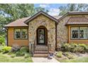 Inviting front porch with stone archway, steps, and decorative plantings leading to a welcoming entrance at 8835 Glencroft Rd, Mint Hill, NC 28227