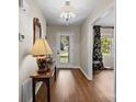 Bright hallway featuring hardwood floors, a decorative mirror, and access to other rooms at 8835 Glencroft Rd, Mint Hill, NC 28227
