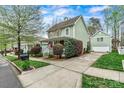 Lovely home featuring a detached garage and a well-manicured lawn at 10210 Roosevelt Dr, Huntersville, NC 28078