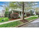 Attractive home with a classic design, complemented by mature trees and lush shrubs at 10210 Roosevelt Dr, Huntersville, NC 28078