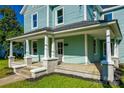Charming two-story home with a covered front porch and beautiful blue siding at 107 Maurice St, Monroe, NC 28112
