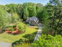 Beautiful home with well-manicured lawn, mature trees, and a long driveway at 108 Tall Oak Dr, Mooresville, NC 28117