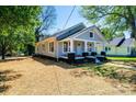 Charming gray home featuring a welcoming front porch with black and white accents at 1143 N College Ave, Newton, NC 28658