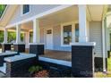 Close-up of a cozy front porch with brick detailing and charming architectural elements at 1143 N College Ave, Newton, NC 28658