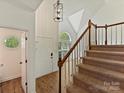 Bright foyer with hardwood floors, a staircase, and a decorative pendant light fixture at 12100 Bay Tree Way, Charlotte, NC 28277
