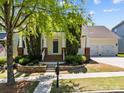 Charming two-story home with a two-car garage and lovely landscaped front yard at 12614 Robert Walker Dr, Davidson, NC 28036
