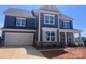 A charming new construction two-story home features a two car garage and a brick foundation at 13304 Chopin Ridge Dr, Huntersville, NC 28078
