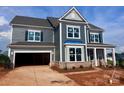 New construction, two-story home features a gray siding, brick base, and an attached two-car garage at 13304 Chopin Ridge Dr, Huntersville, NC 28078
