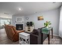Cozy living room featuring a fireplace, comfortable seating, and natural light at 1347 Mifflin Ln, Dallas, NC 28034
