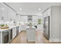 Bright, all-white kitchen featuring stainless steel appliances and a center island for food preparation at 143 Ross Rd, Mooresville, NC 28117