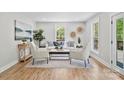 Bright living room featuring neutral tones, stylish decor, and natural light from large windows at 143 Ross Rd, Mooresville, NC 28117