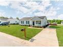 Inviting single-story home with a well-kept lawn, a paved driveway, and classic architectural details at 15 Wright St, Rock Hill, SC 29730