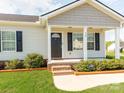Welcoming front porch with brick steps, white columns, and landscaped bushes flanking the entrance at 15 Wright St, Rock Hill, SC 29730