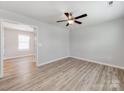 Bright, airy living room with light-colored walls, wood-look floors, and a modern ceiling fan at 15 Wright St, Rock Hill, SC 29730
