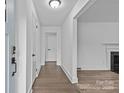 Open foyer with hardwood floors, white walls, and a view of the living room at 1601 Gambia St, Charlotte, NC 28208