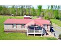 Charming single-story home featuring red roof and cozy front porch, surrounded by a lush green lawn at 161 Hickory Nut Dr, Statesville, NC 28677