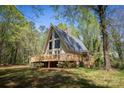Charming A-frame home with a spacious wraparound deck surrounded by lush greenery at 1680 Ne 17Th Avenue Ct, Hickory, NC 28601