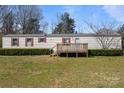 One-story home with a cozy front porch, red shutters, and a spacious front lawn at 189 Woodwinds Dr, Mooresville, NC 28115