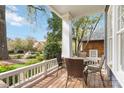 Inviting outdoor porch with wood flooring and a dining set, perfect for enjoying meals outdoors at 1921 Brandon Cir, Charlotte, NC 28211