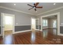 Spacious living room featuring hardwood floors, neutral walls, and a ceiling fan at 2015 Dilworth E Rd, Charlotte, NC 28203