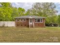 Quaint brick home featuring a well-maintained lawn and inviting entrance at 2106 A Ave, Charlotte, NC 28216