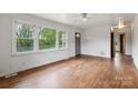 Bright living room with large windows and hardwood floors at 2106 A Ave, Charlotte, NC 28216