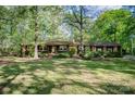 Traditional home with a covered porch and well-maintained lawn, perfect for enjoying the outdoors in a tranquil setting at 2415 Hargette Rd, Monroe, NC 28112