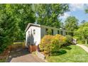 Side view of the home showing the driveway, fence, and yard at 2528 Arnold Dr, Charlotte, NC 28205