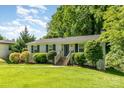 Beautiful one-story home with a well-maintained lawn and mature trees at 2528 Arnold Dr, Charlotte, NC 28205