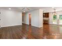 Open-concept living room featuring hardwood floors, crown molding, and neutral walls at 2528 Arnold Dr, Charlotte, NC 28205