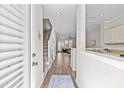 Inviting foyer with hardwood floors, staircase, and open view into the living spaces at 2638 Dilworth Heights Ln, Charlotte, NC 28209