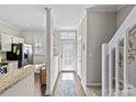 Hallway view with hardwood floors leading to the kitchen, stairs and outdoor access at 2638 Dilworth Heights Ln, Charlotte, NC 28209