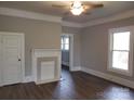 Open living room featuring freshly painted walls, an ornate fireplace, and laminate flooring at 301 E 11Th St, Kannapolis, NC 28083