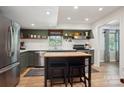 Modern kitchen with stainless steel appliances, island, butcher block countertop, and stylish open shelving at 308 Greenwood Pl, Belmont, NC 28012