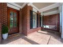 Charming front porch features a swing, brick siding, and a wood door with glass panels at 3301 Mcpherson St, Waxhaw, NC 28173